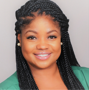 A woman with long braids and a green shirt